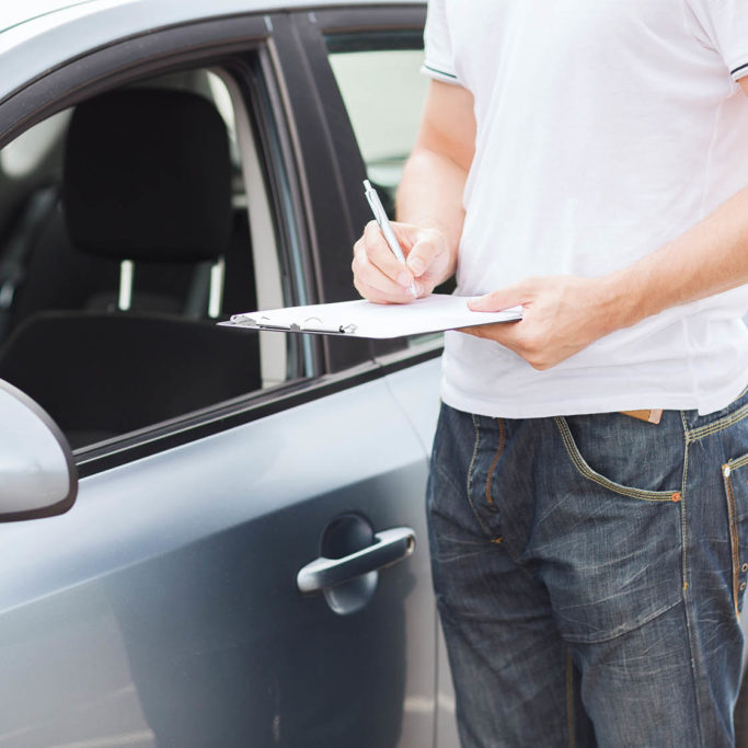 transportation and ownership concept - man with car documents